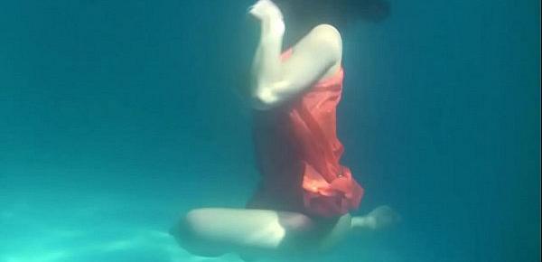  Red dressed mermaid Rusalka swimming in the pool